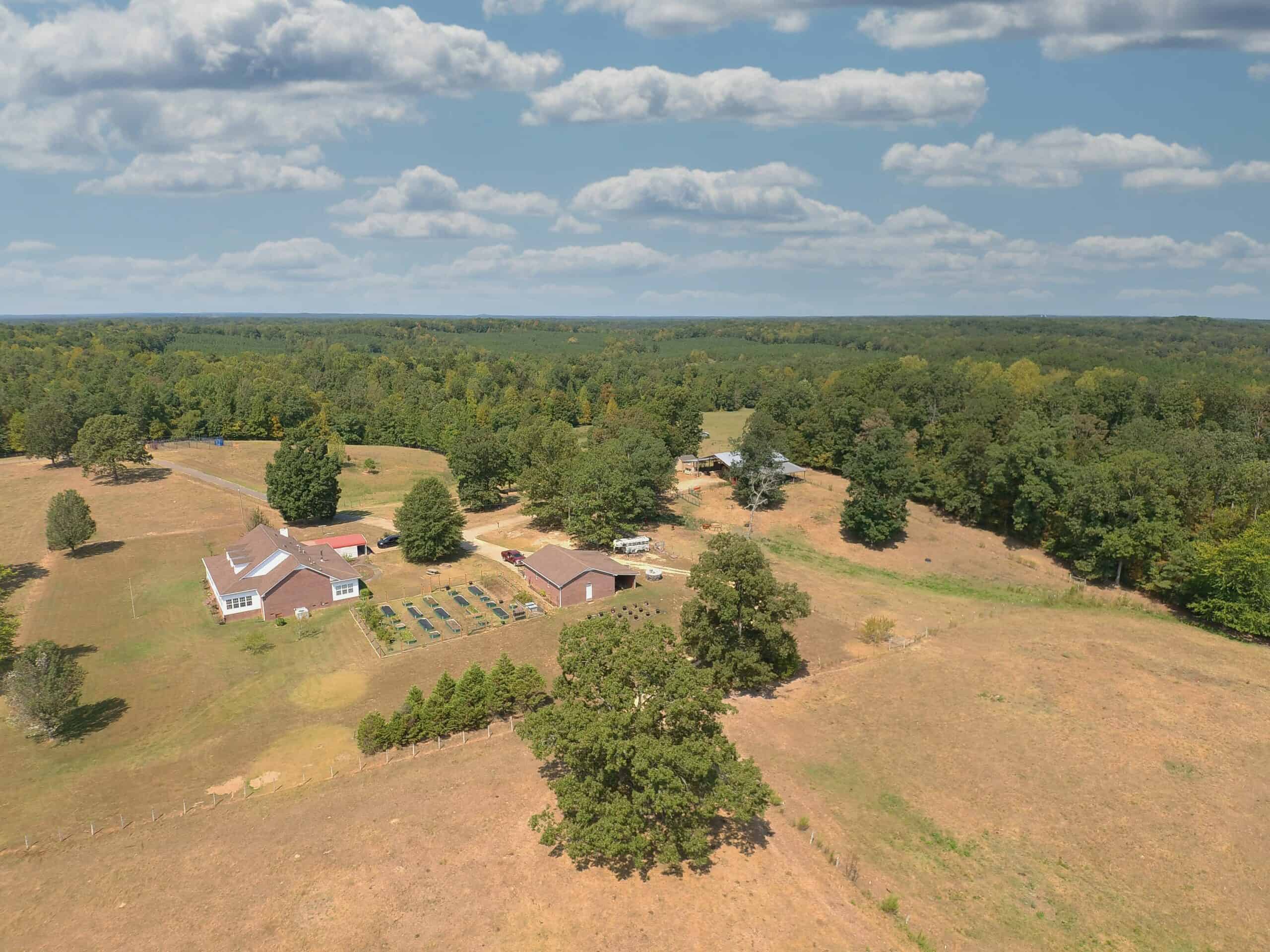PRIVATE FARM FOR SALE IN TN NEAR TENNESSEE RIVER WITH POND, CREEK, FENCING, PASTURES, AND SHOP. GREAT DEER HUNTING.