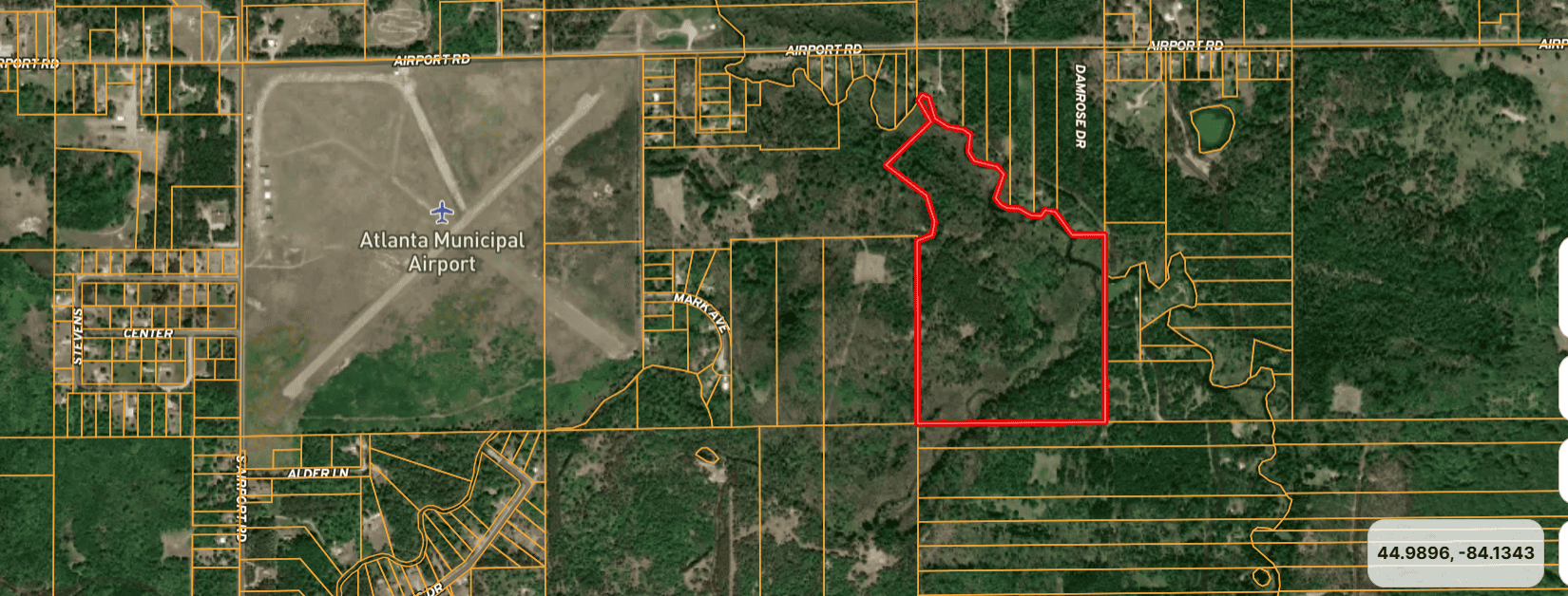56 Acres of Woodlands & Waterfront Serenity in Atlanta MI