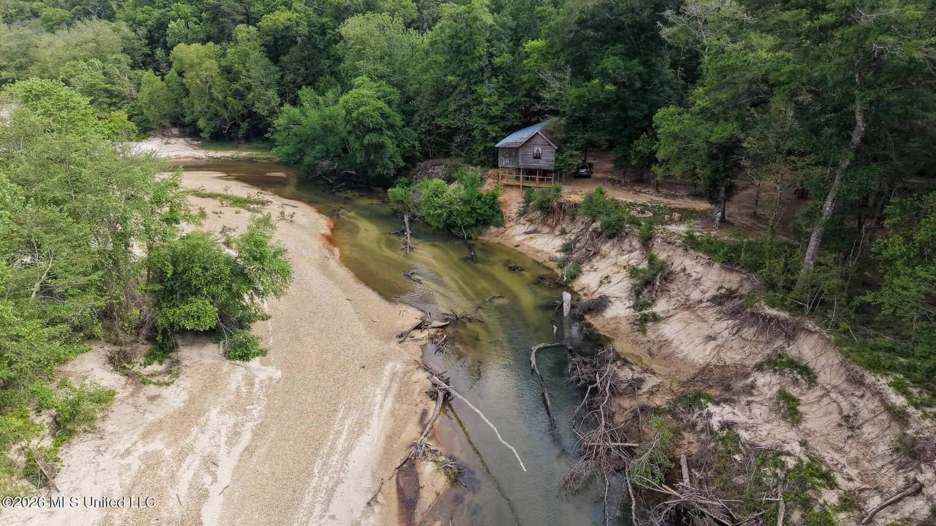23 Acres of Riverfront Property with Sand Bar and Cabins