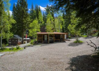 Colorado Mountain Hunting Retreat Surrounded By Thousands of Acres of Public Land in Garfield County With Low Flowing Creek and Multiple Cabins and Lodge