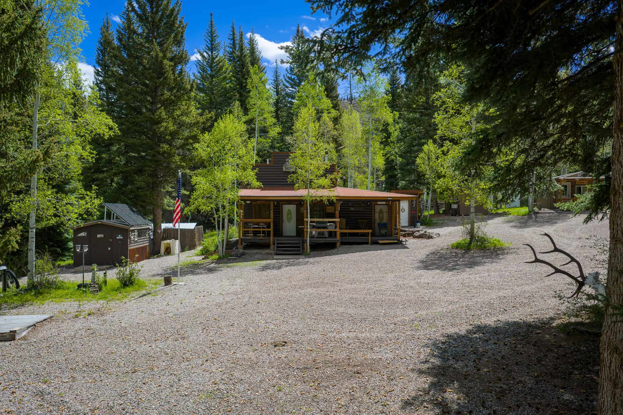 Colorado Mountain Hunting Retreat Surrounded By Thousands of Acres of Public Land in Garfield County With Low Flowing Creek and Multiple Cabins and Lodge
