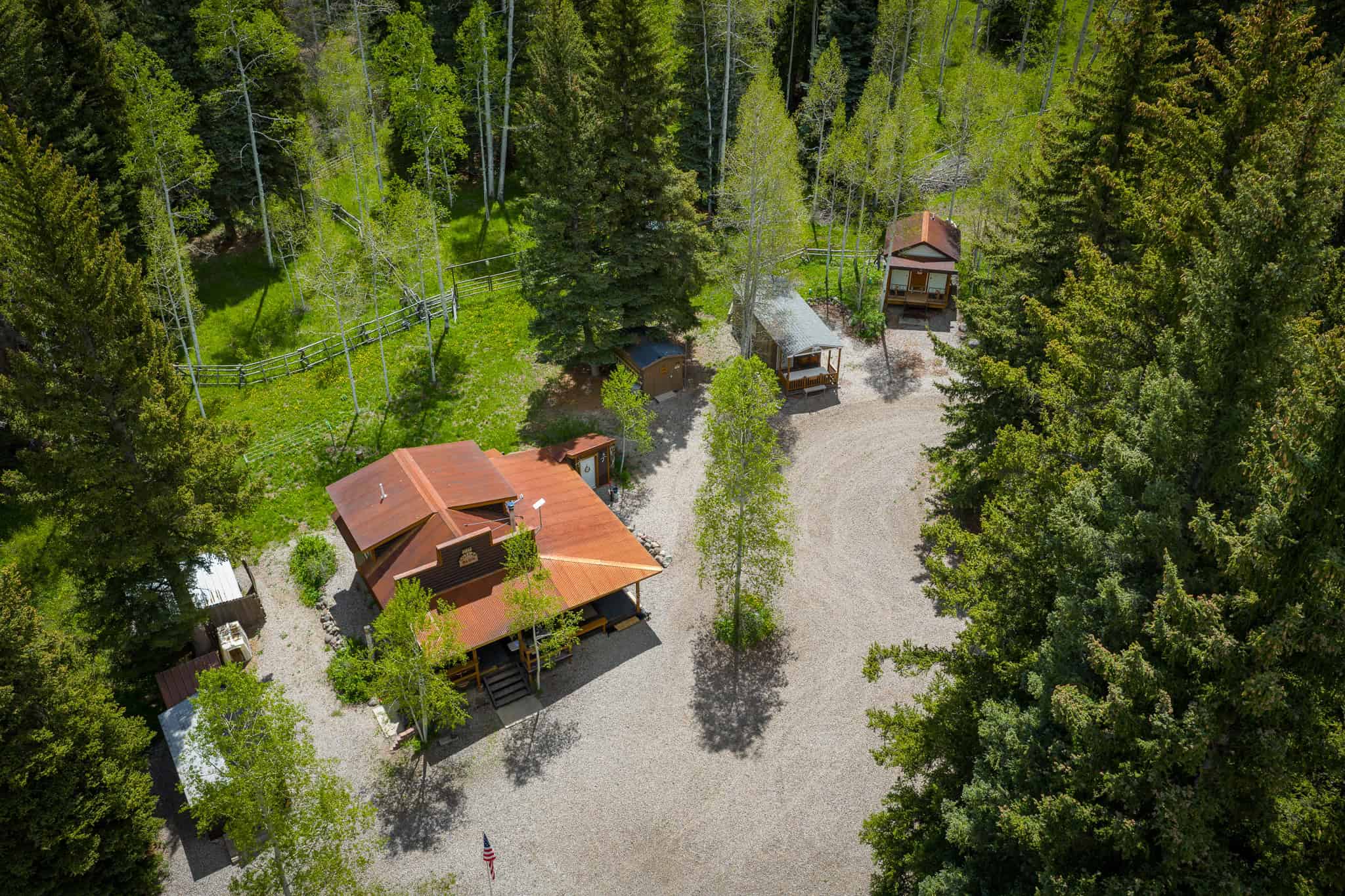 Colorado Mountain Hunting Retreat Surrounded By Thousands of Acres of Public Land in Garfield County With Low Flowing Creek and Multiple Cabins and Lodge