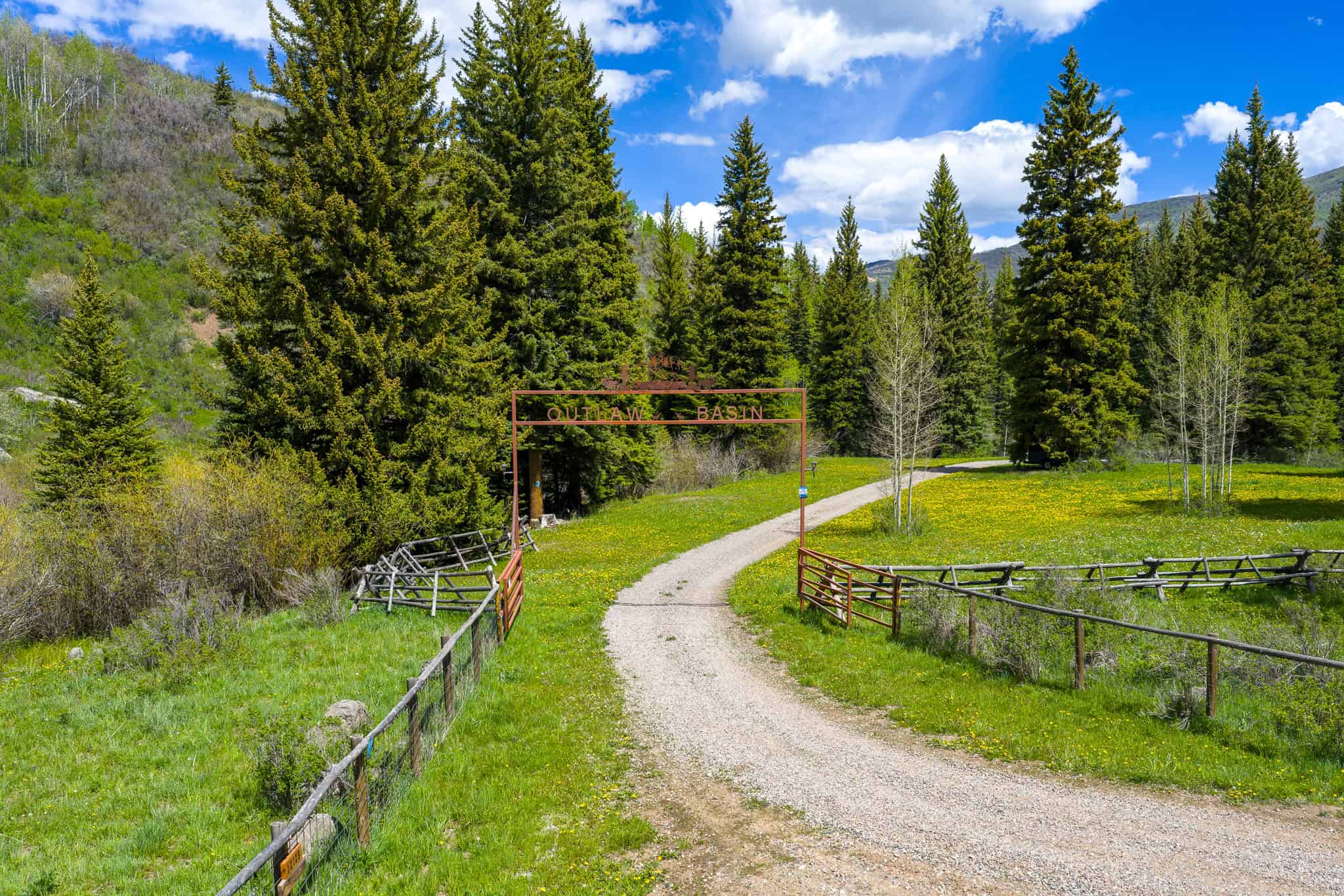 Colorado Mountain Hunting Retreat Surrounded By Thousands of Acres of Public Land in Garfield County With Low Flowing Creek and Multiple Cabins and Lodge