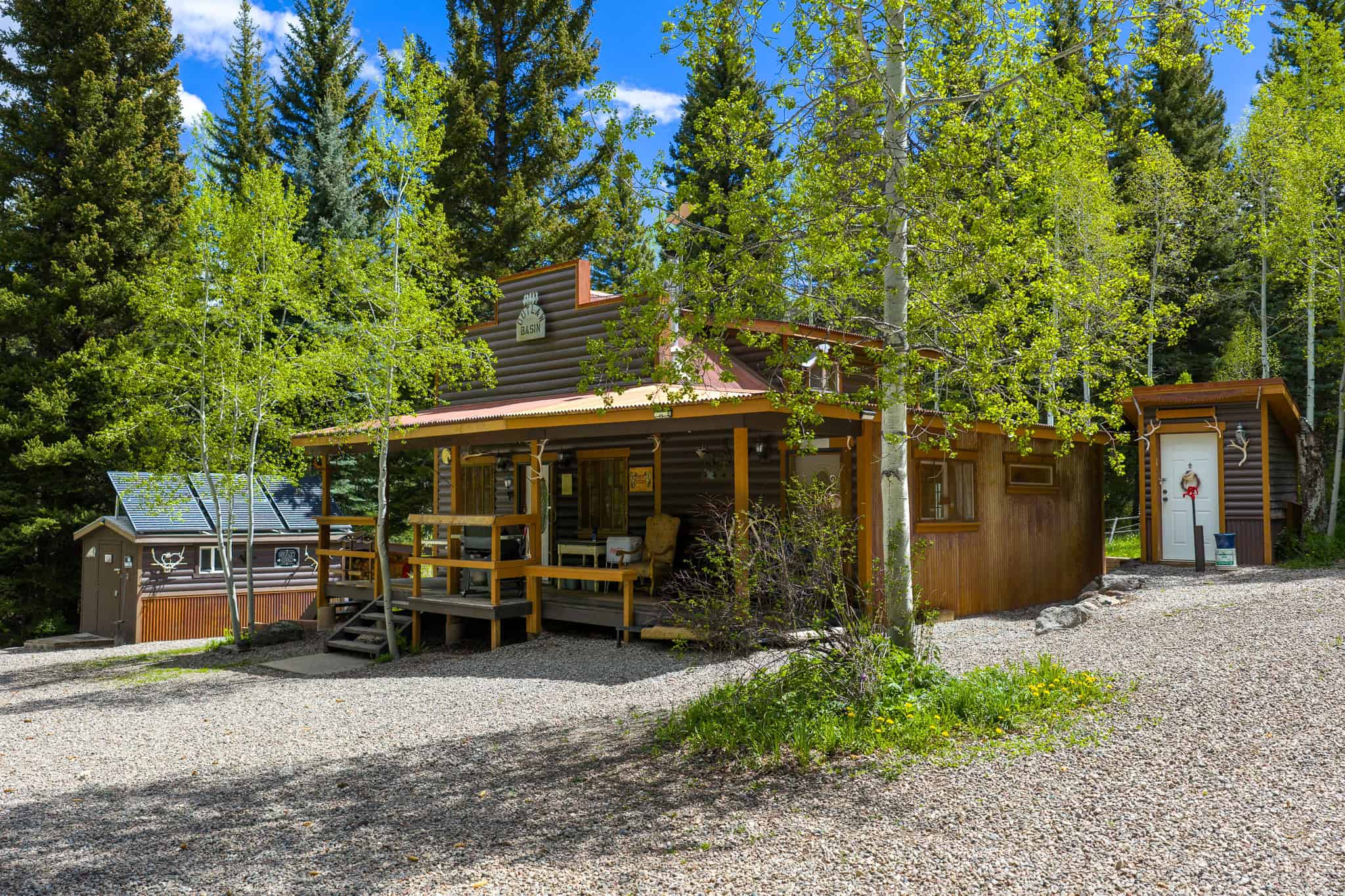 Colorado Mountain Hunting Retreat Surrounded By Thousands of Acres of Public Land in Garfield County With Low Flowing Creek and Multiple Cabins and Lodge
