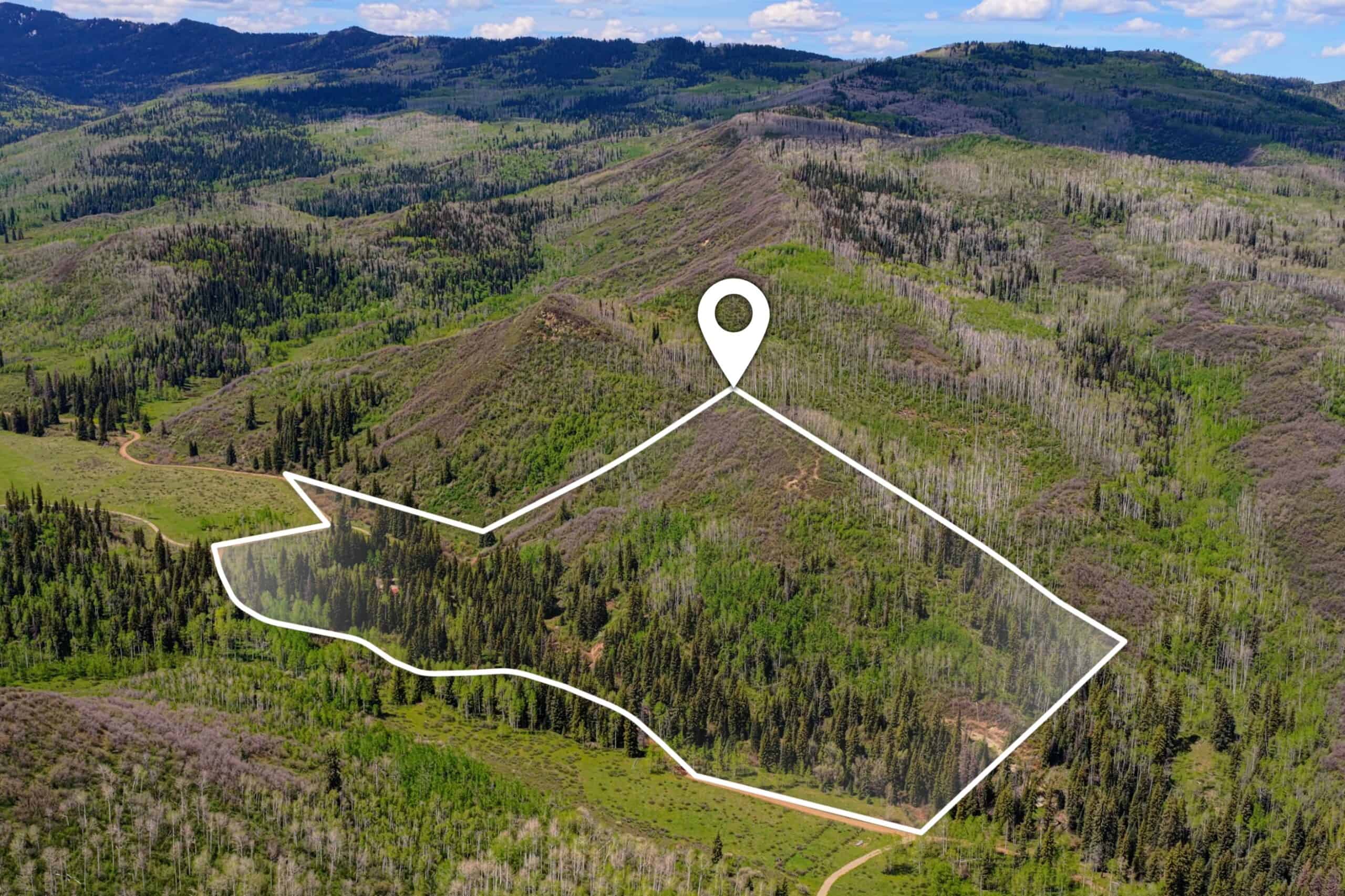 Colorado Mountain Hunting Retreat Surrounded By Thousands of Acres of Public Land in Garfield County With Low Flowing Creek and Multiple Cabins and Lodge