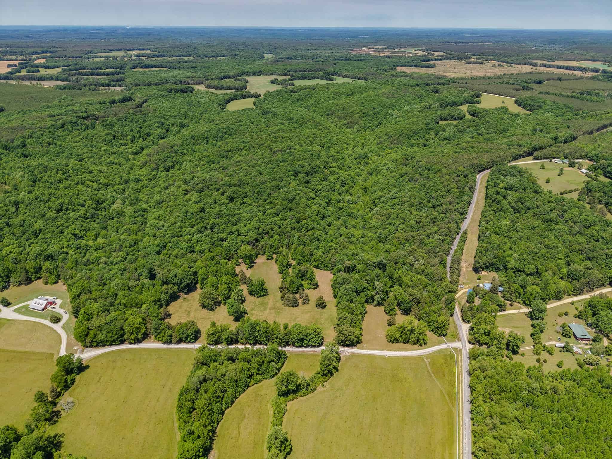 PRIVATE 394 ACRE TENNESSEE ESTATE WITH HOME, SHOP, CREEK, POND,TEARMING WITH WHITETAIL DEER AND TURKEY