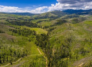 Colorado Mountain Hunting Retreat Surrounded By Thousands of Acres of Public Land in Garfield County With Low Flowing Creek and Multiple Cabins and Lodge