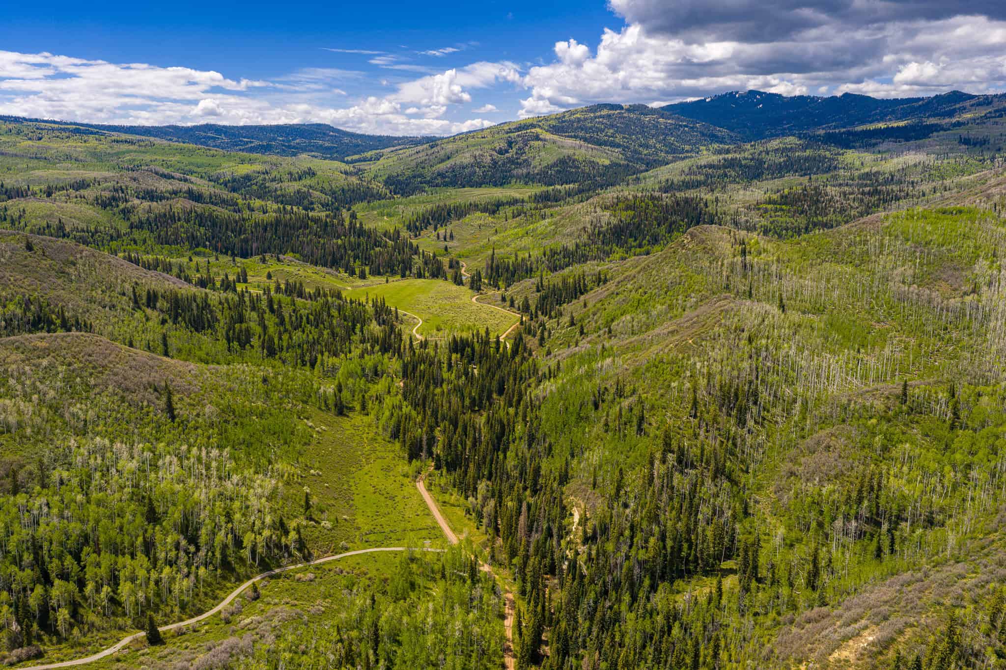 Colorado Mountain Hunting Retreat Surrounded By Thousands of Acres of Public Land in Garfield County With Low Flowing Creek and Multiple Cabins and Lodge